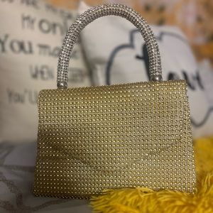 A gold handbag/ purse